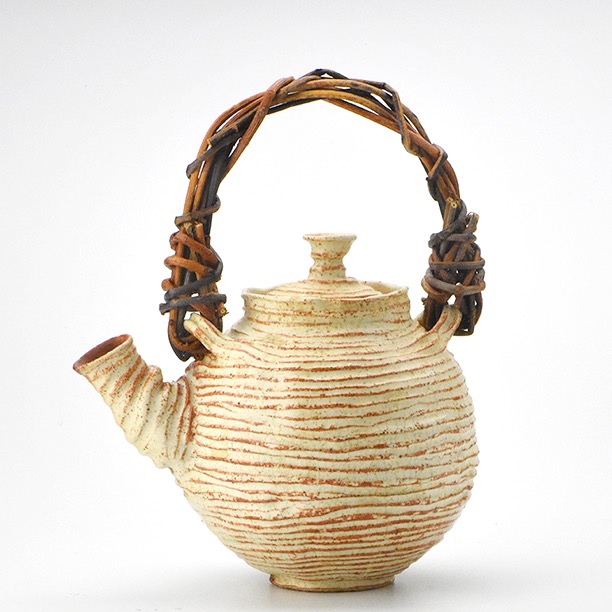 Stoneware teapot with Akebia handle.
